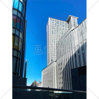 青空が見える都会のビルの隙間の写真素材